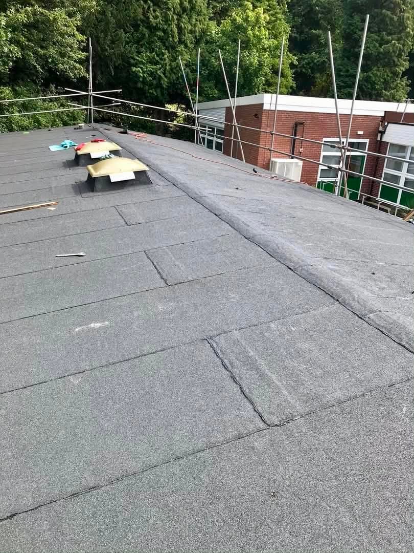 Large commercial built-up felt roof in progress with new vents fitted