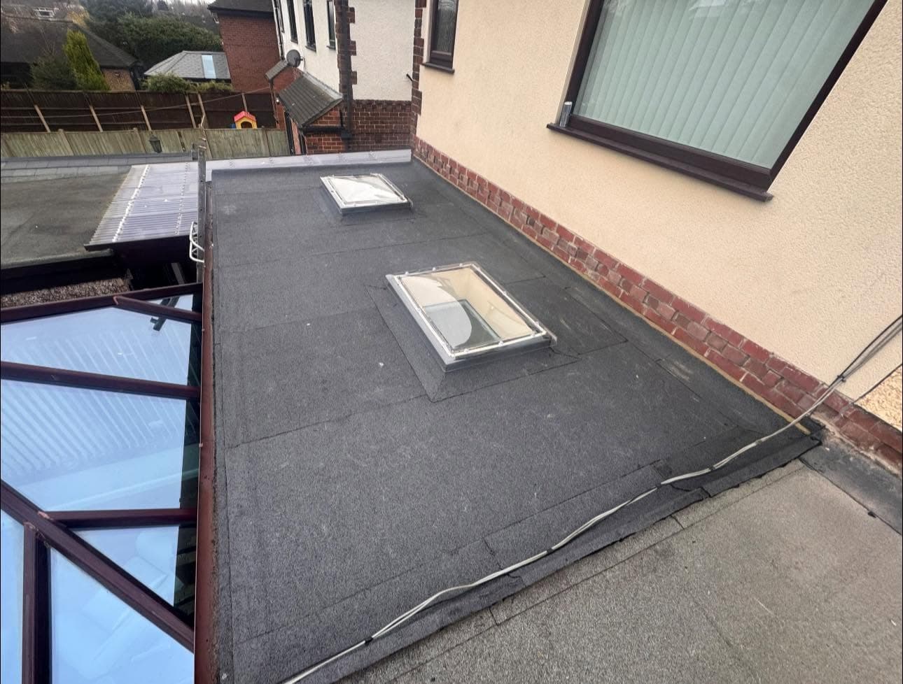 The same flat roof after a new built-up felt system and rooflights were installed