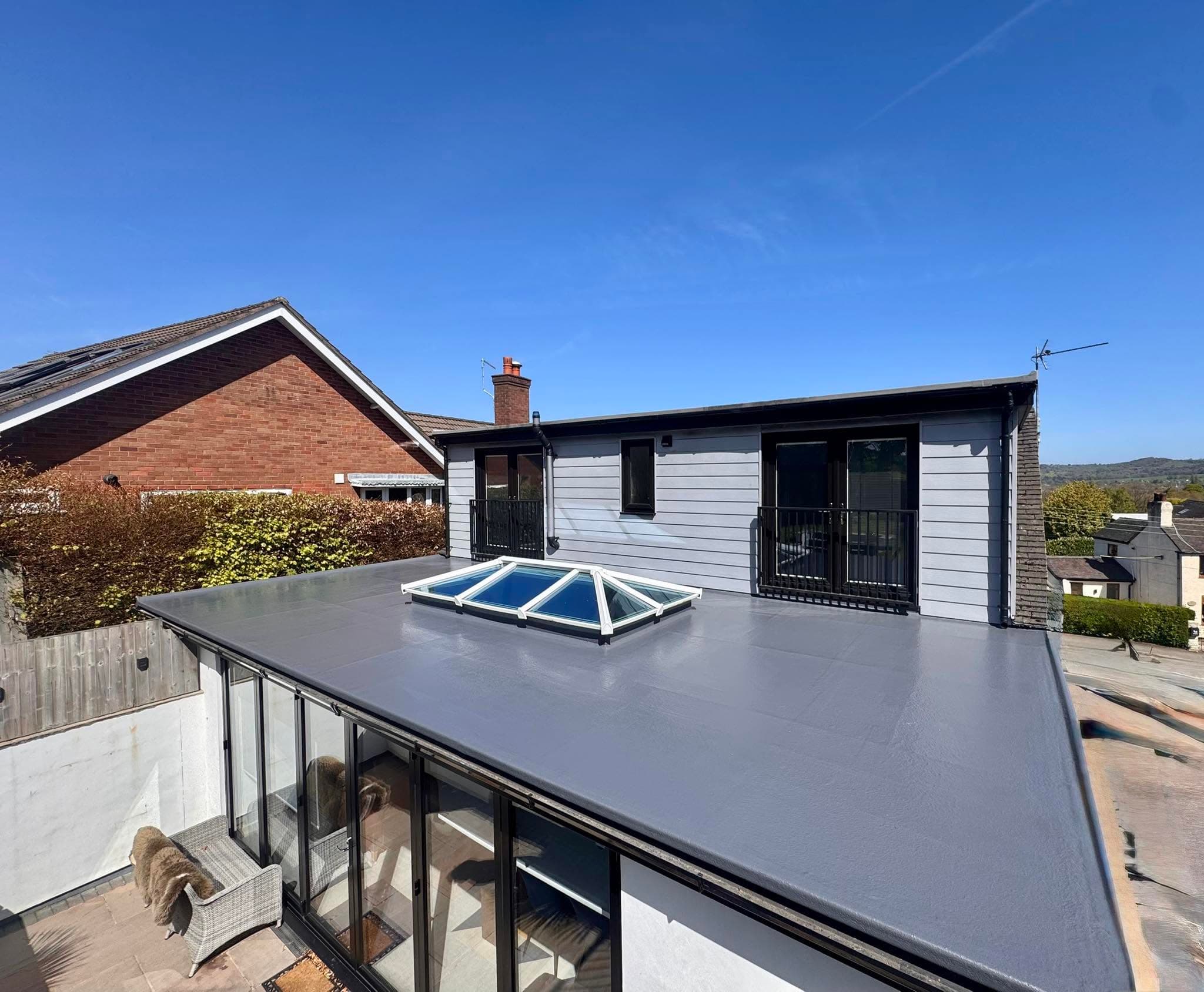 A finished grey GRP fibreglass flat roof with a glass roof lantern on a home near Stoke-on-Trent