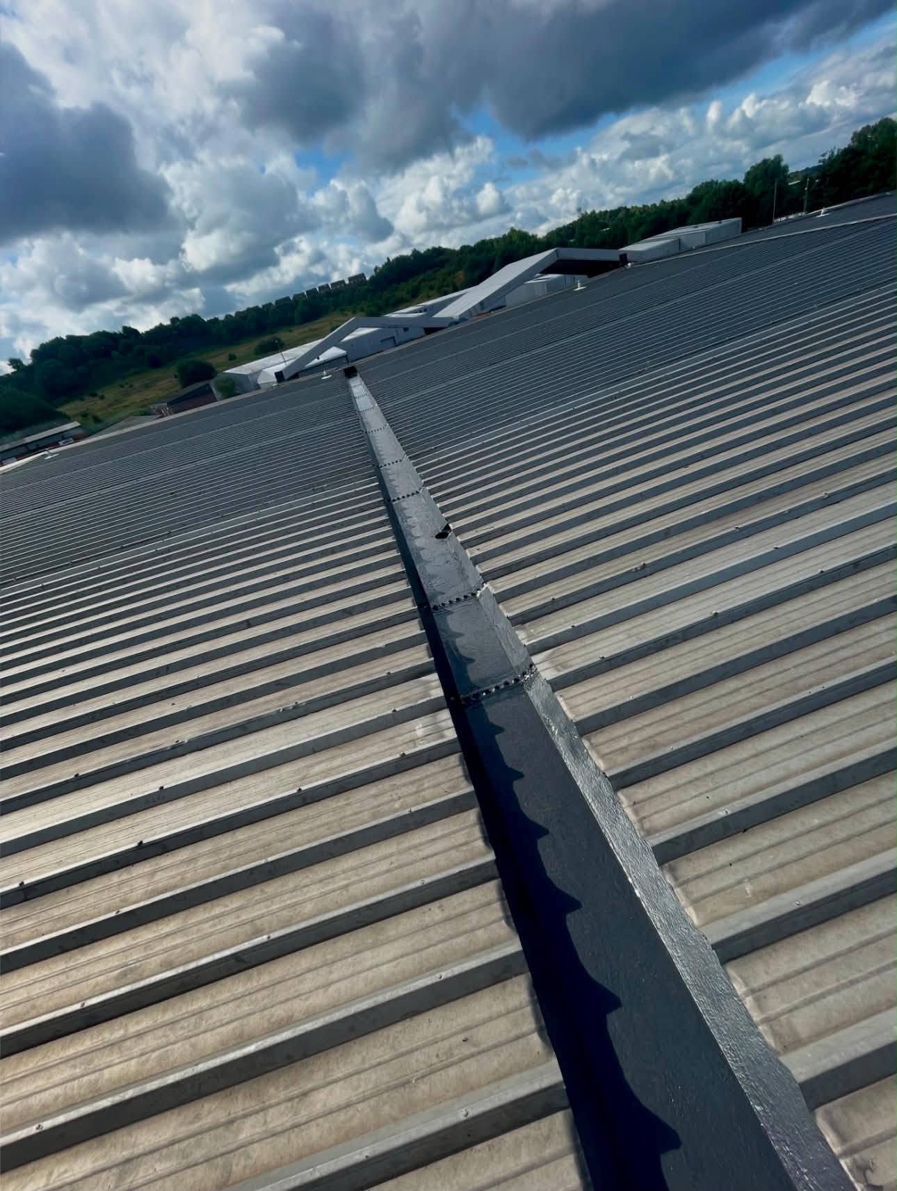 Long run of liquid applied waterproofing on an industrial roof valley