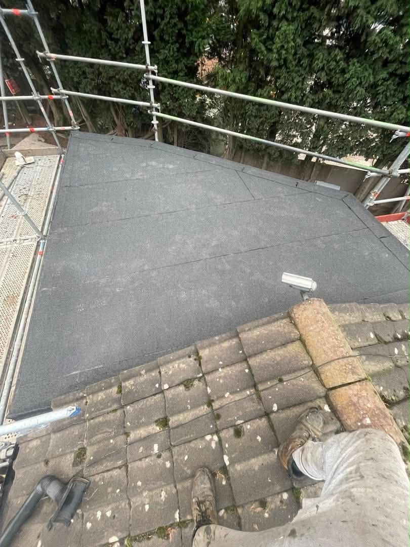 An Abbotts roofer on the deck during a felt re-roof